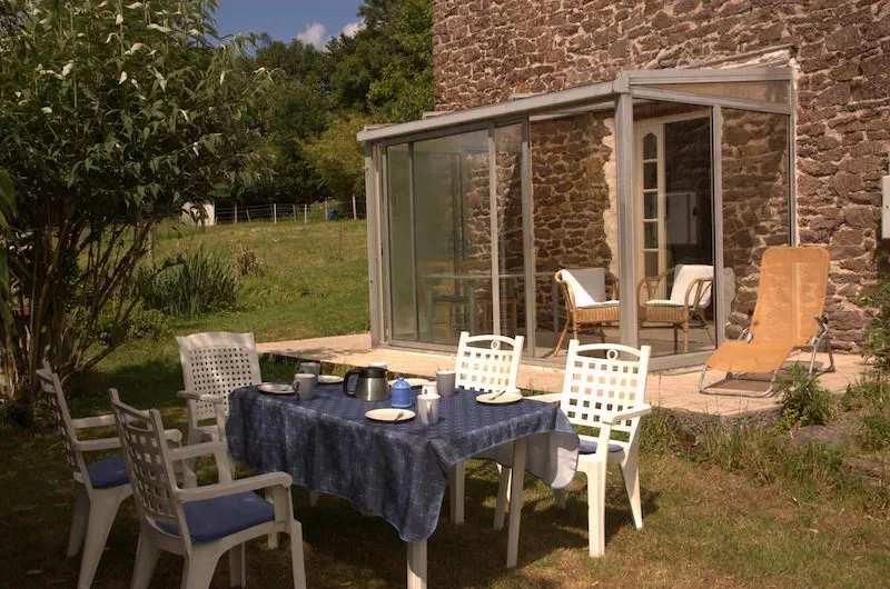 Salon de jardin devant la véranda et le gîte Bambou